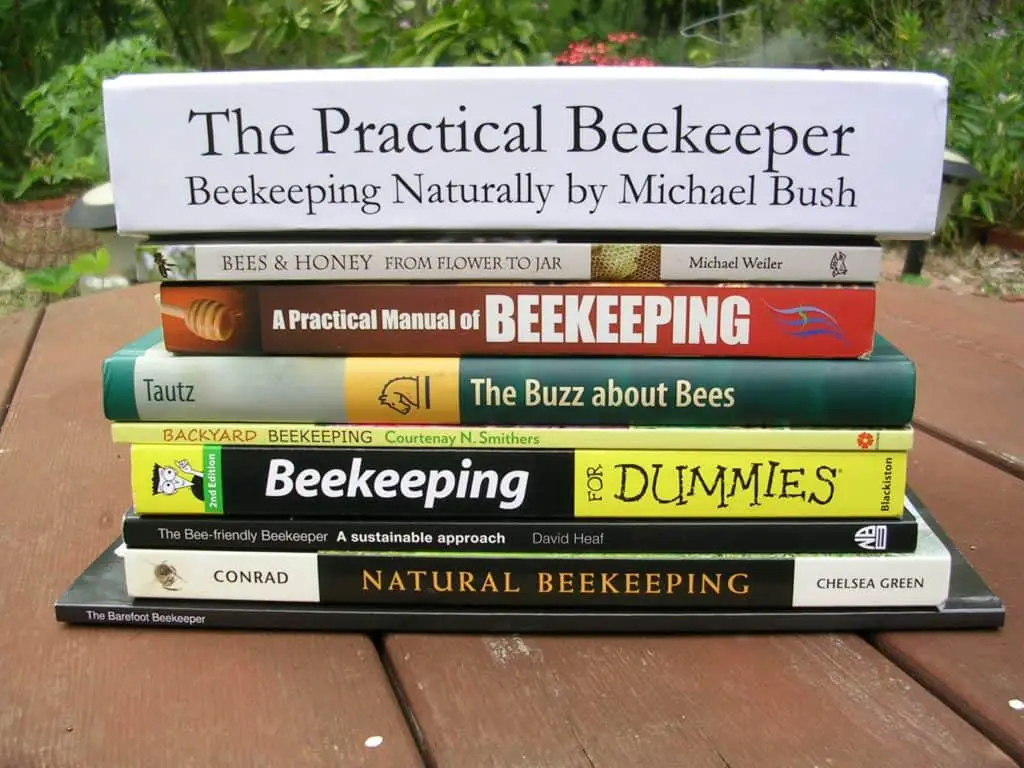Beekeeping books stacked on a table
