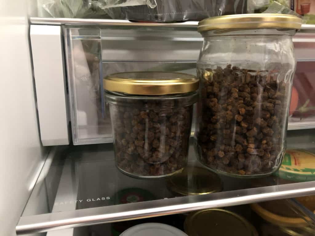 Two jars of bee bread placed in a fridge
